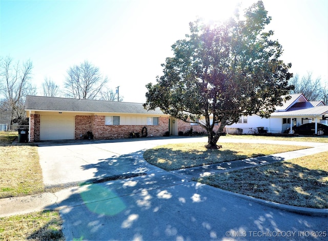 236 W 7th Ave, Bristow, OK 74010 - ranch-style house with brick siding, a garage, driveway, and a front lawn