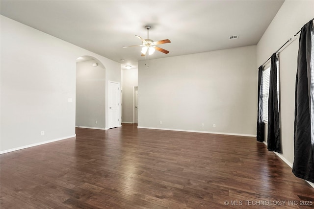 5612 N 31st St, Broken Arrow, OK 74014 - spare room with arched walkways, a ceiling fan, and dark wood finished floors