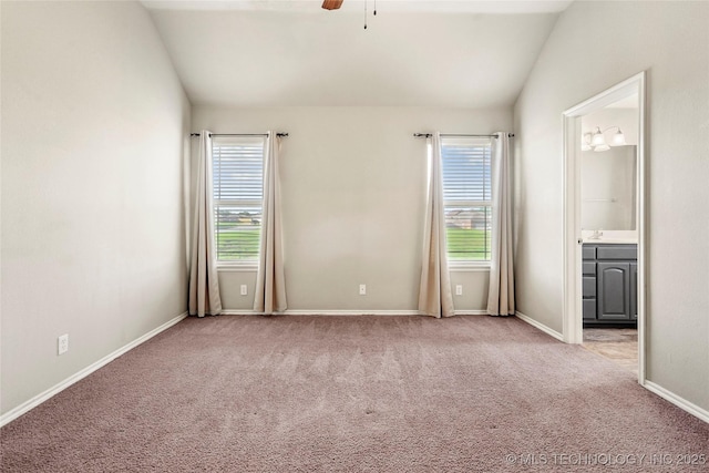 5612 N 31st St, Broken Arrow, OK 74014 - unfurnished bedroom with lofted ceiling, multiple windows, carpet flooring, connected bathroom, and a ceiling fan
