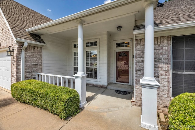 19722 E 50th Ct S, Broken Arrow, OK 74014 - entrance to property featuring covered porch, a shingled roof, brick siding, and a garage