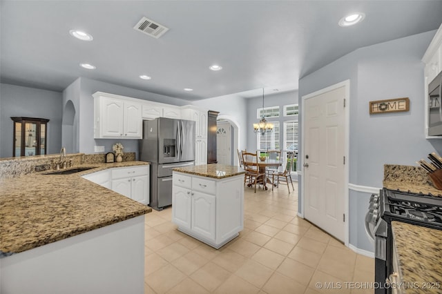 19722 E 50th Ct S, Broken Arrow, OK 74014 - kitchen featuring arched walkways, stainless steel appliances, a chandelier, white cabinetry, and recessed lighting