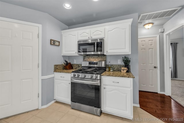 19722 E 50th Ct S, Broken Arrow, OK 74014 - kitchen with stainless steel appliances, dark stone counters, white cabinetry, recessed lighting, and light wood-type flooring