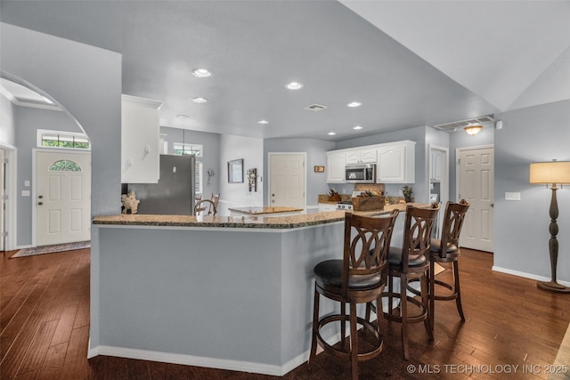 19722 E 50th Ct S, Broken Arrow, OK 74014 - kitchen with stainless steel appliances, dark wood-style floors, light stone counters, white cabinetry, and recessed lighting