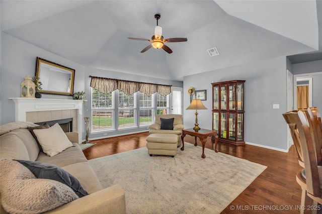 19722 E 50th Ct S, Broken Arrow, OK 74014 - living area featuring ceiling fan, a tile fireplace, wood finished floors, and high vaulted ceiling
