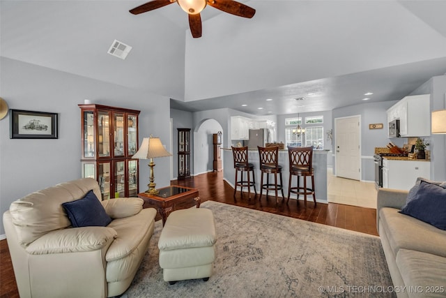 19722 E 50th Ct S, Broken Arrow, OK 74014 - living area featuring dark wood-style floors, a ceiling fan, recessed lighting, a chandelier, and high vaulted ceiling