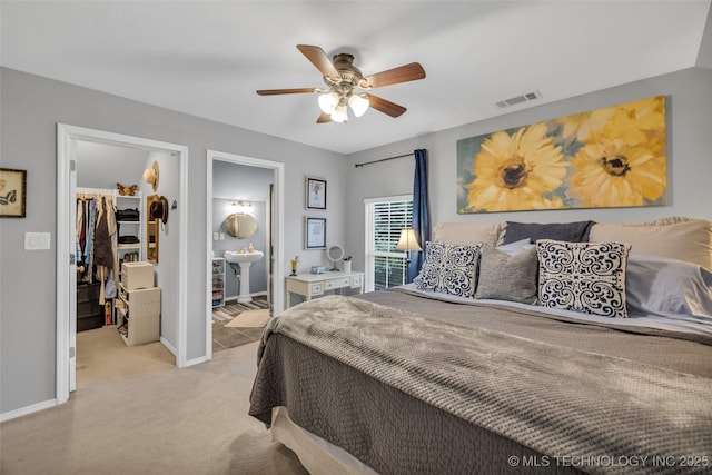 19722 E 50th Ct S, Broken Arrow, OK 74014 - bedroom with a spacious closet, a closet, carpet floors, connected bathroom, and a ceiling fan