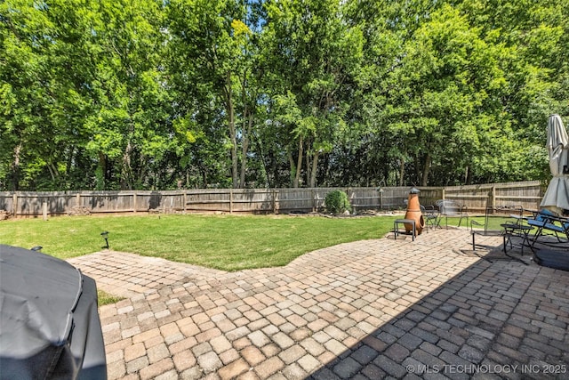 19722 E 50th Ct S, Broken Arrow, OK 74014 - fenced backyard featuring a patio, grilling area, and view of scattered trees