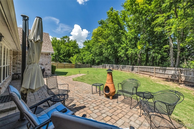 19722 E 50th Ct S, Broken Arrow, OK 74014 - fenced backyard with a patio area and view of scattered trees