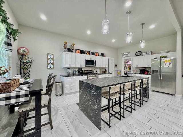 3309 S 116th E Pl, Tulsa, OK 74146 - kitchen featuring stainless steel appliances, a breakfast bar area, light marble finish floors, white cabinets, and recessed lighting