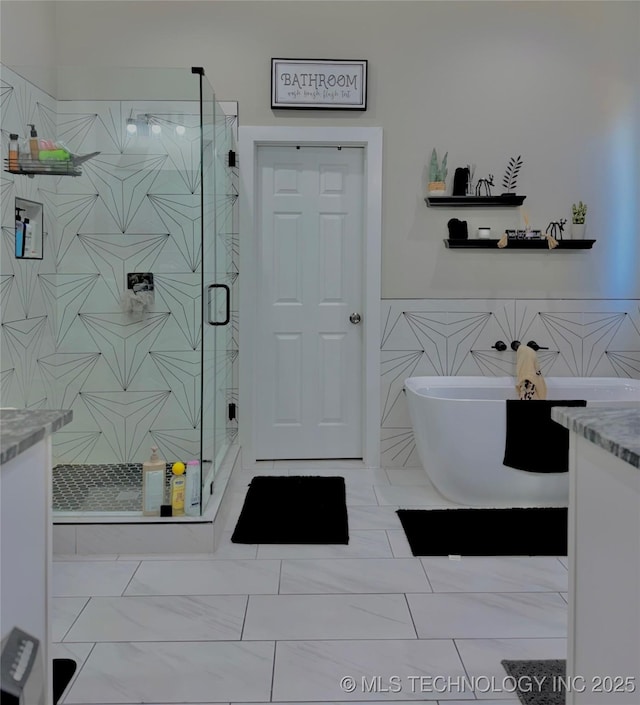 3309 S 116th E Pl, Tulsa, OK 74146 - full bathroom with a shower stall, vanity, tile walls, a freestanding bath, and a wainscoted wall