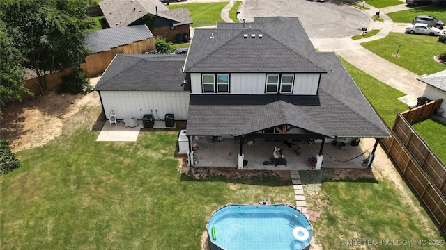 3309 S 116th E Pl, Tulsa, OK 74146 - back of property featuring a shingled roof, a patio, and a fenced backyard