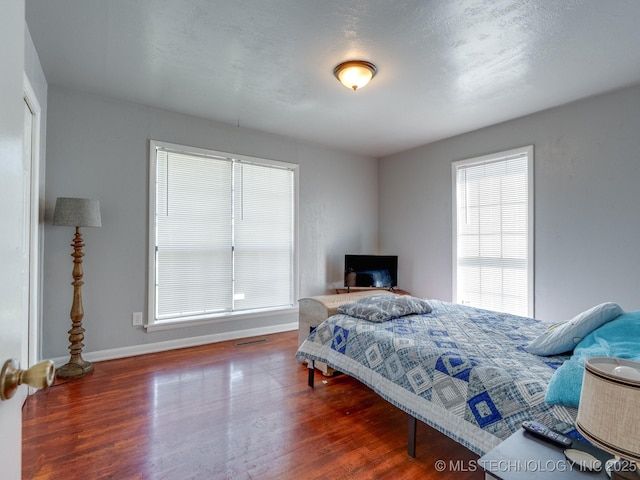 825 W 22nd St, Ada, OK 74820 - bedroom with wood finished floors and a closet