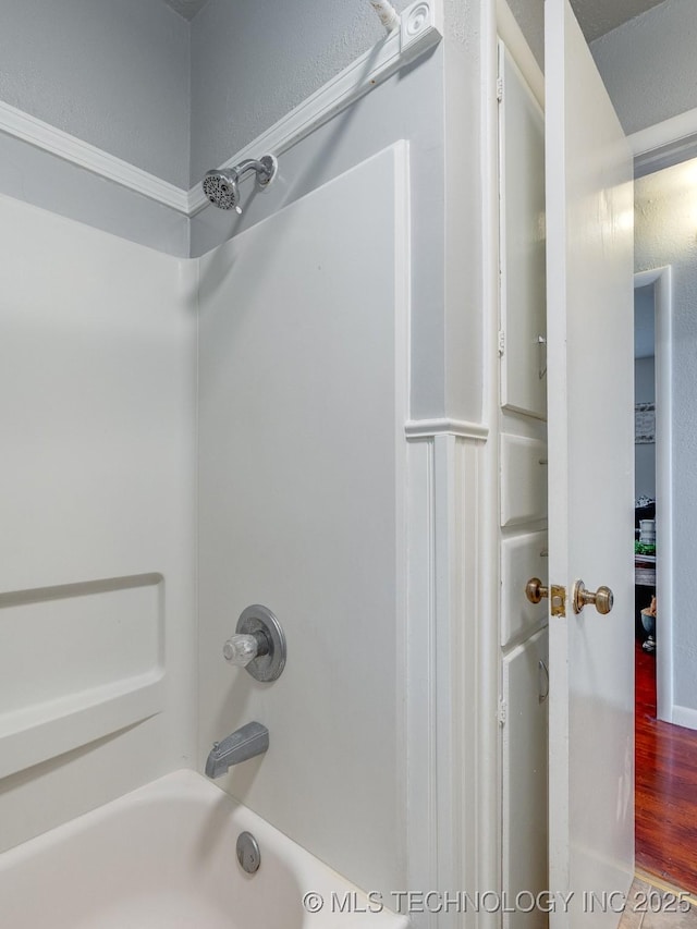 825 W 22nd St, Ada, OK 74820 - full bathroom with shower / bathtub combination and wood finished floors