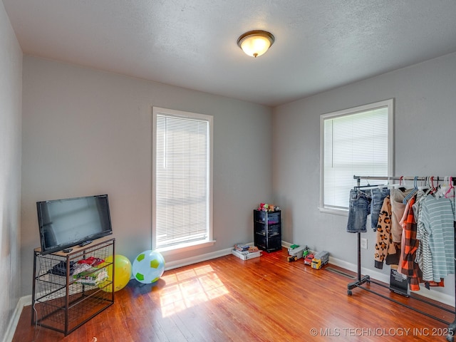 825 W 22nd St, Ada, OK 74820 - rec room with wood finished floors and baseboards