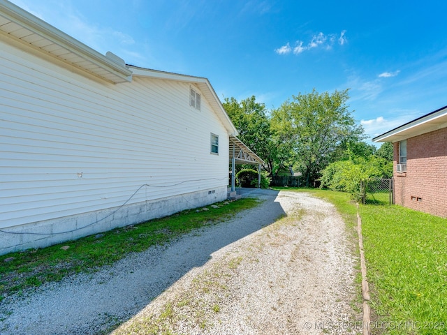825 W 22nd St, Ada, OK 74820 - view of home's exterior with dirt driveway and crawl space