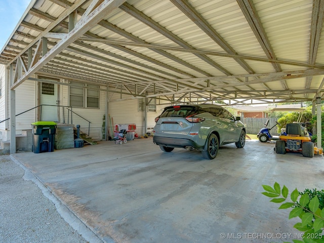 825 W 22nd St, Ada, OK 74820 - garage featuring a carport