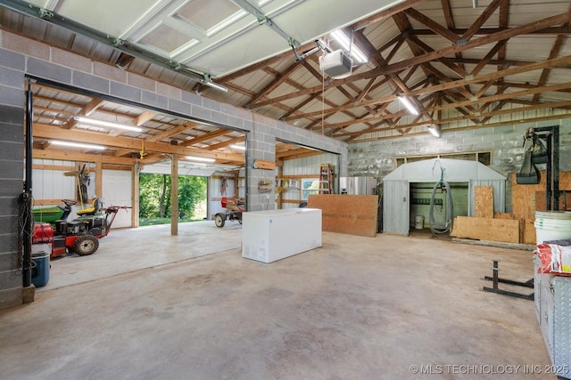 441059 E 155th Rd, Bluejacket, OK 74333 - garage with refrigerator and a garage door opener
