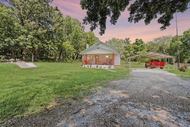 441059 E 155th Rd, Bluejacket, OK 74333 - bungalow-style home featuring a carport, driveway, a front lawn, a chimney, and covered porch