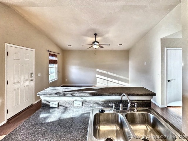 8932 S 258th E Ave, Broken Arrow, OK 74014 - kitchen featuring dark wood-style flooring, ceiling fan, vaulted ceiling, and a textured ceiling