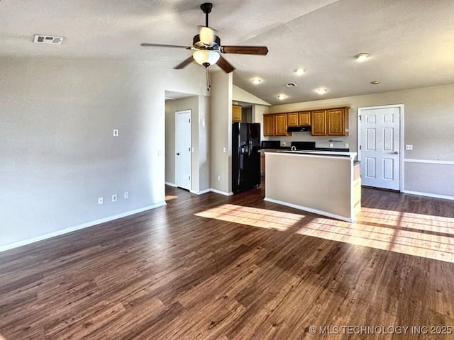 8932 S 258th E Ave, Broken Arrow, OK 74014 - kitchen featuring black fridge with ice dispenser, lofted ceiling, open floor plan, brown cabinetry, and under cabinet range hood