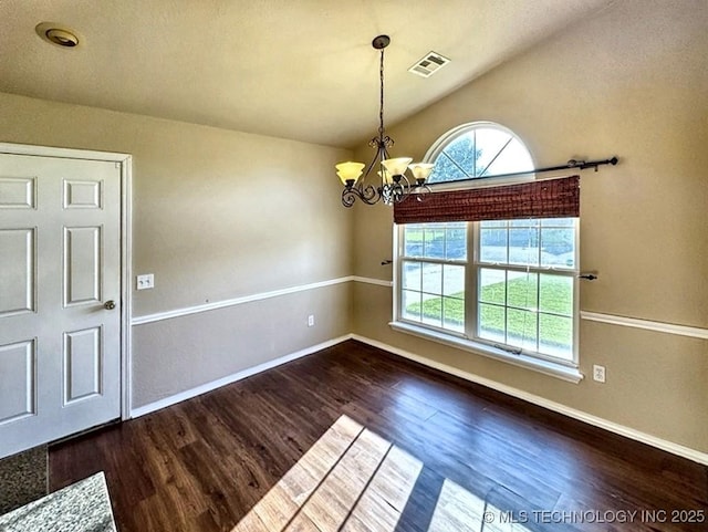 8932 S 258th E Ave, Broken Arrow, OK 74014 - unfurnished dining area featuring healthy amount of natural light, wood finished floors, a chandelier, and vaulted ceiling