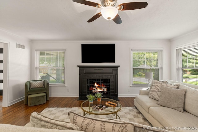 3447 S Gary Pl, Tulsa, OK 74105 - living room featuring a fireplace with flush hearth, wood finished floors, crown molding, and ceiling fan