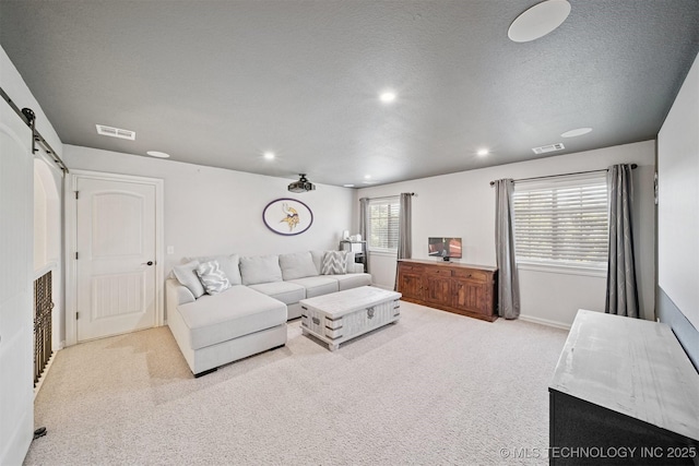 16410 E 49th St, Tulsa, OK 74134 - carpeted living room with a barn door, recessed lighting, and a textured ceiling