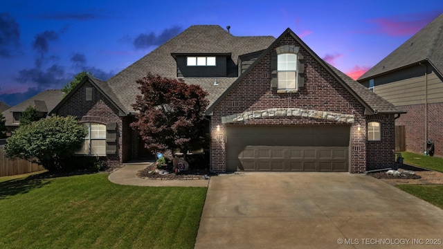 16410 E 49th St, Tulsa, OK 74134 - view of front of home with brick siding, driveway, a yard, roof with shingles, and an attached garage
