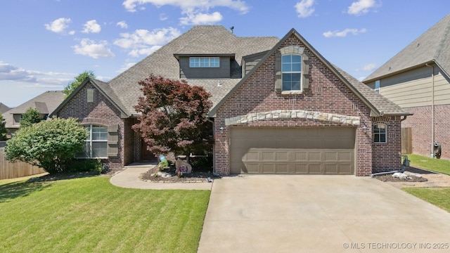 16410 E 49th St, Tulsa, OK 74134 - view of front of house with brick siding, a front yard, driveway, and a shingled roof