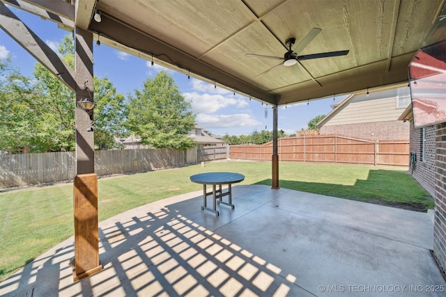 16410 E 49th St, Tulsa, OK 74134 - fenced backyard featuring a ceiling fan and a patio area
