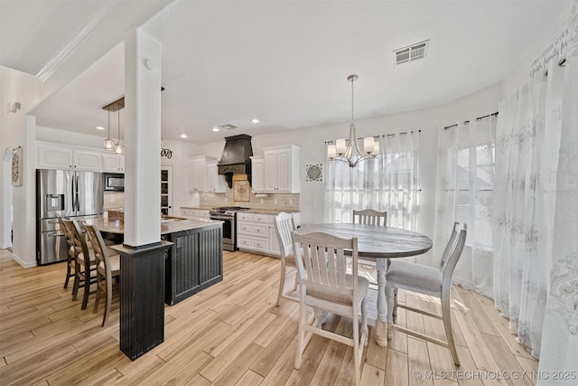 16410 E 49th St, Tulsa, OK 74134 - kitchen featuring stainless steel appliances, custom exhaust hood, white cabinetry, a chandelier, and recessed lighting