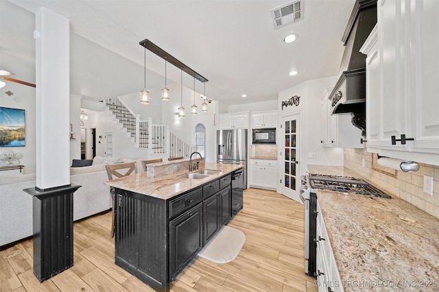 16410 E 49th St, Tulsa, OK 74134 - kitchen featuring black appliances, dark cabinetry, white cabinetry, light wood-style flooring, and open floor plan