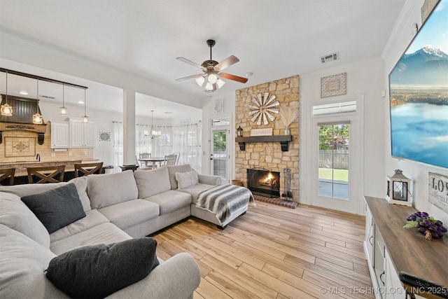 16410 E 49th St, Tulsa, OK 74134 - living area with ceiling fan, light wood-style floors, a fireplace, crown molding, and a chandelier