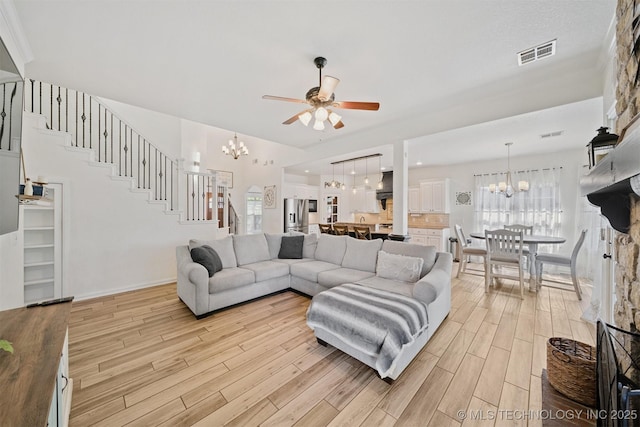 16410 E 49th St, Tulsa, OK 74134 - living area featuring a chandelier, light wood-style floors, and a ceiling fan