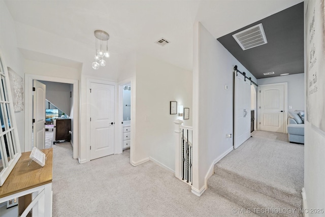 16410 E 49th St, Tulsa, OK 74134 - hall with carpet floors, a barn door, and a chandelier