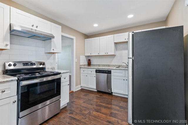232 E Mohawk Blvd, Tulsa, OK 74106 - kitchen featuring appliances with stainless steel finishes, under cabinet range hood, tasteful backsplash, white cabinets, and dark wood-type flooring