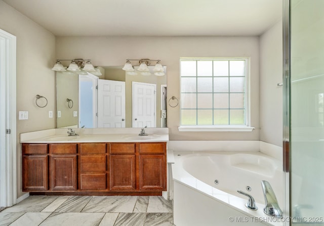 20409 E 49th St S, Broken Arrow, OK 74014 - full bath with double vanity, a jetted tub, and marble finish flooring