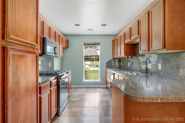 20409 E 49th St S, Broken Arrow, OK 74014 - kitchen featuring black microwave, stainless steel range with gas stovetop, dark countertops, backsplash, and recessed lighting
