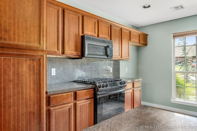 20409 E 49th St S, Broken Arrow, OK 74014 - kitchen featuring stainless steel range with gas cooktop, black microwave, brown cabinets, decorative backsplash, and recessed lighting