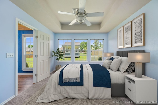 20409 E 49th St S, Broken Arrow, OK 74014 - carpeted bedroom featuring a tray ceiling and ceiling fan