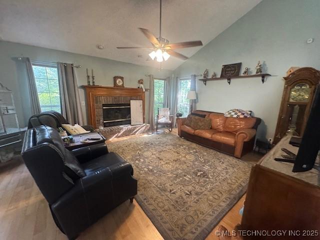 7412 W 38th St, Tulsa, OK 74107 - living area featuring a ceiling fan, a fireplace, wood finished floors, and lofted ceiling