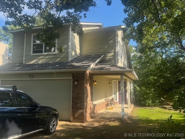 7412 W 38th St, Tulsa, OK 74107 - view of side of home with a garage and brick siding