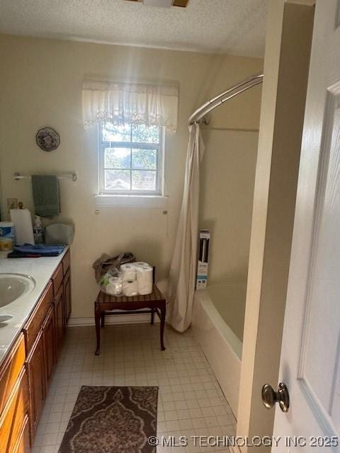 7412 W 38th St, Tulsa, OK 74107 - bathroom featuring a textured ceiling, vanity, shower / bath combo with shower curtain, and tile patterned floors