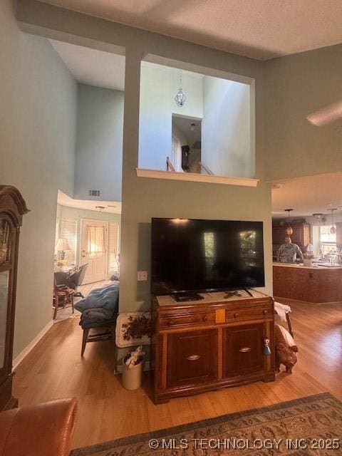 7412 W 38th St, Tulsa, OK 74107 - living room featuring a high ceiling and wood finished floors