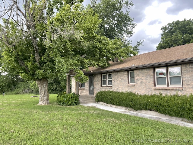 55250 E 297th Rd, Afton, OK 74331 - view of front facade with brick siding, a front yard, and roof with shingles