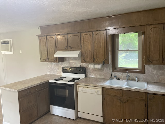 55250 E 297th Rd, Afton, OK 74331 - kitchen with white appliances, under cabinet range hood, a peninsula, tasteful backsplash, and a textured ceiling