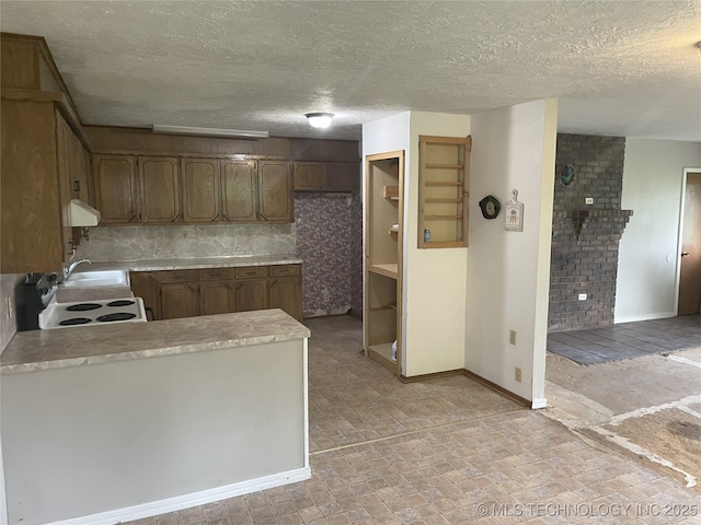 55250 E 297th Rd, Afton, OK 74331 - kitchen with light countertops, a peninsula, a textured ceiling, and white electric stove
