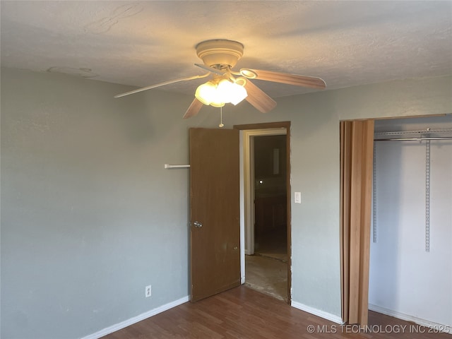 55250 E 297th Rd, Afton, OK 74331 - unfurnished bedroom featuring wood finished floors, a closet, and a ceiling fan