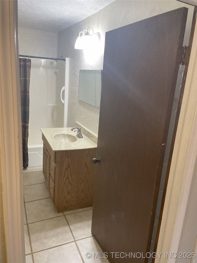 55250 E 297th Rd, Afton, OK 74331 - bathroom with a textured ceiling, vanity, a textured wall, shower / tub combo with curtain, and tile patterned flooring