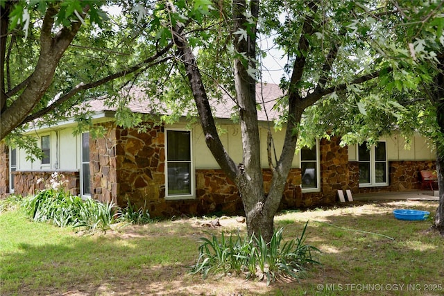 27855 S 170th Rd, Henryetta, OK 74437 - view of side of property featuring stone siding, a shingled roof, and stucco siding